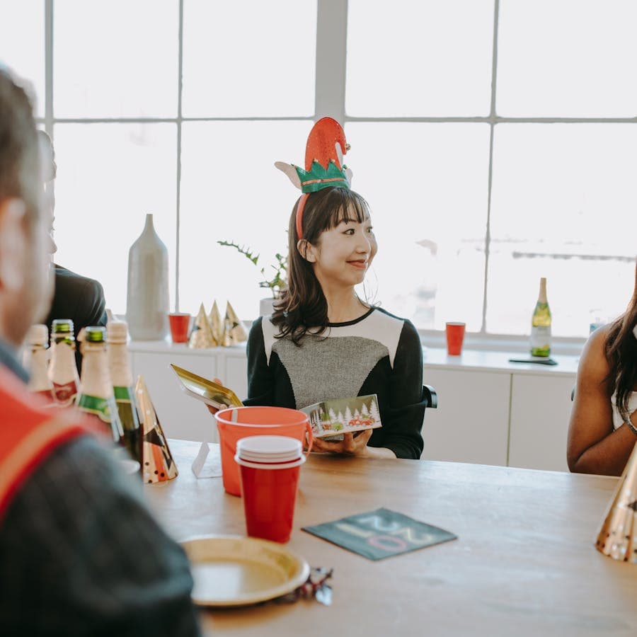 Guest opening a holiday card at the party table