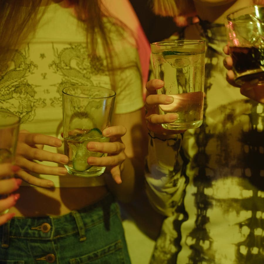 Close-up of hands holding drinks at a party
