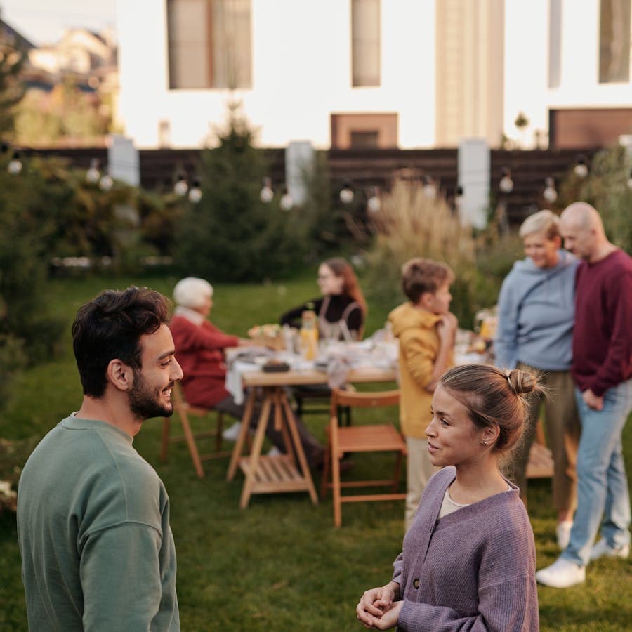 Two relatives having a quiet conversation outdoors