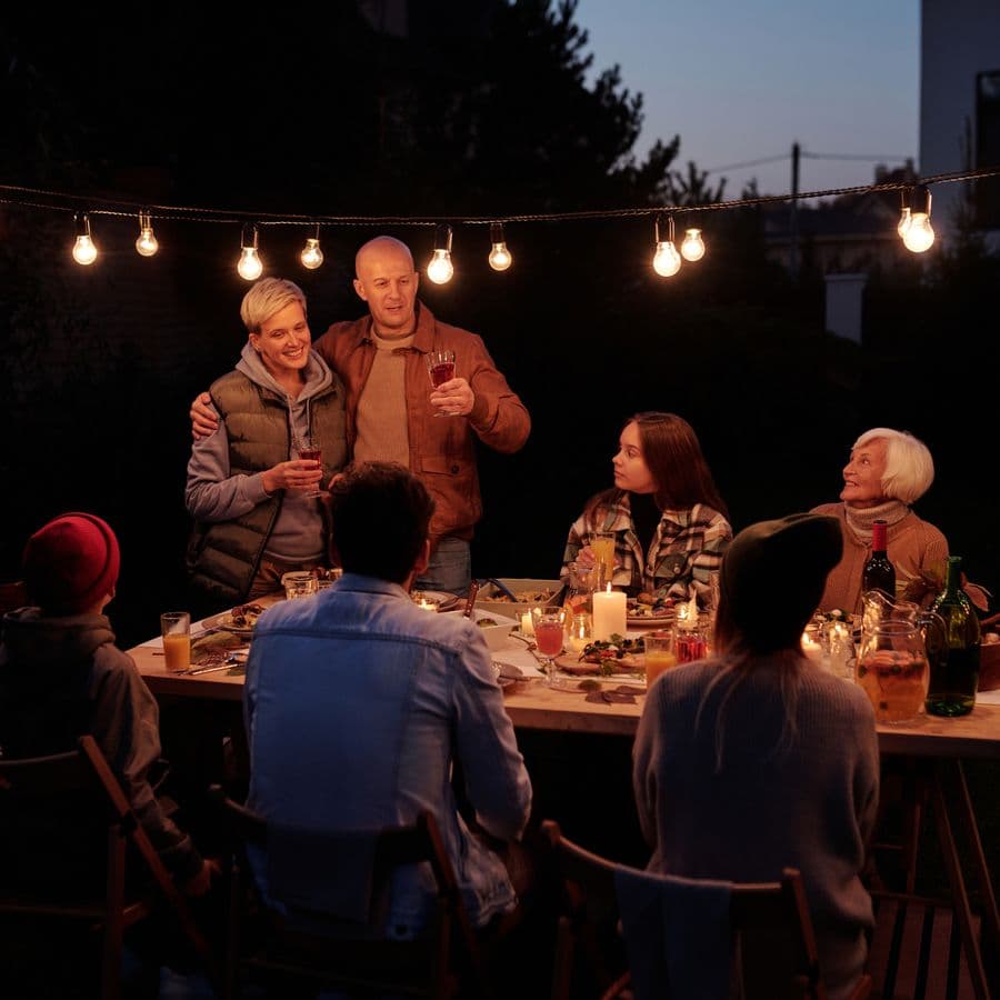 Family gathered for dinner outdoors at dusk