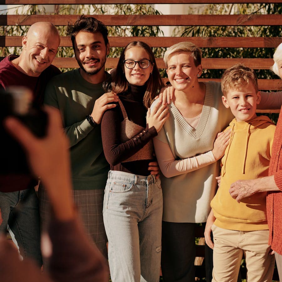 Multigenerational family posing together for a photo outdoors