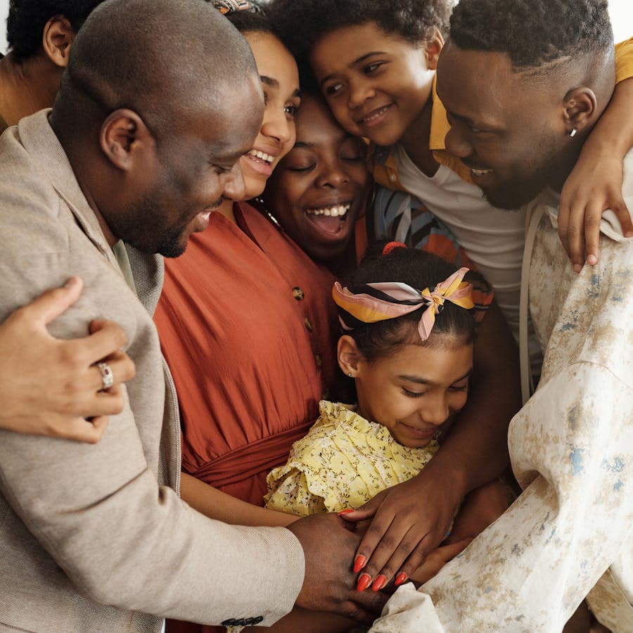Family sharing a big group hug together
