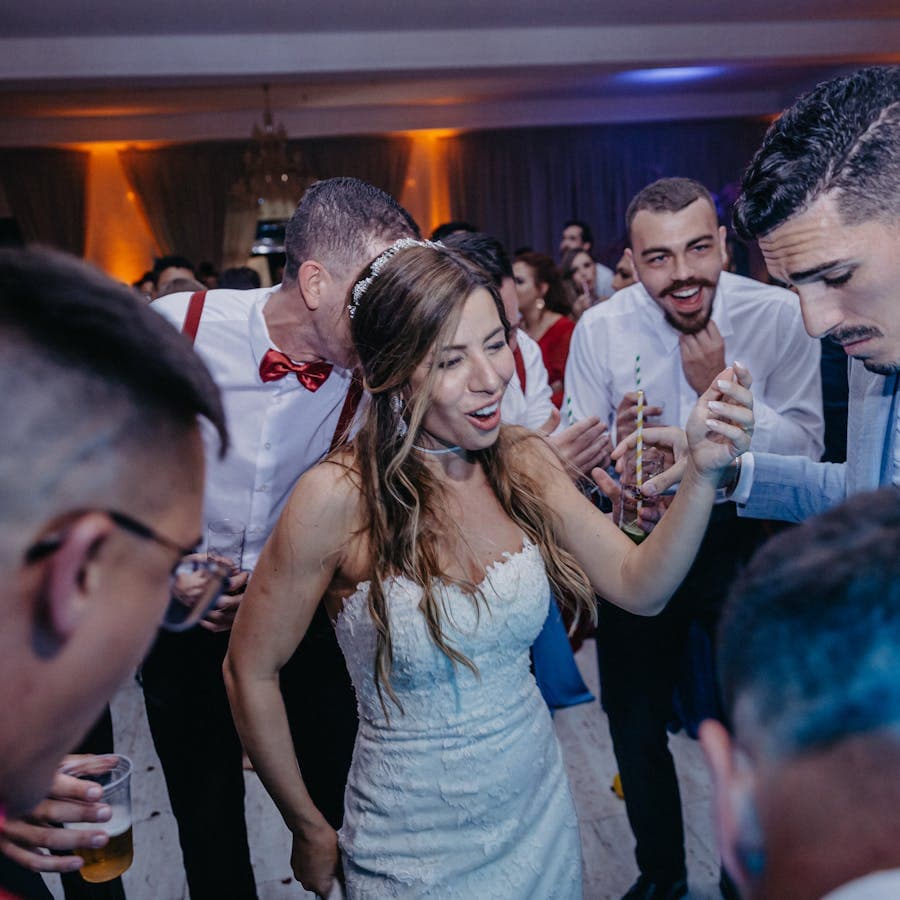 Newlyweds and guests dancing together at the reception