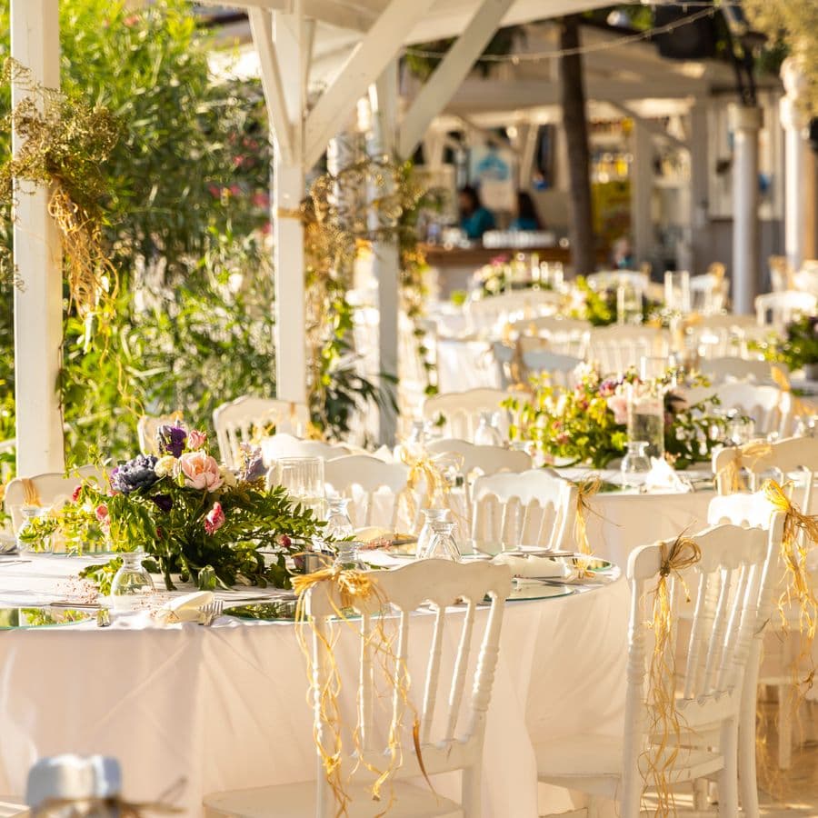 Floral centerpieces on elegantly set reception tables